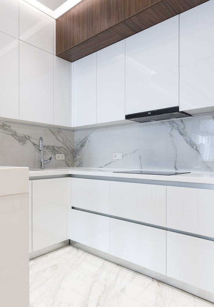 heros-img Sleek, white kitchen design highlighting modern cabinetry and elegant marble finishes.